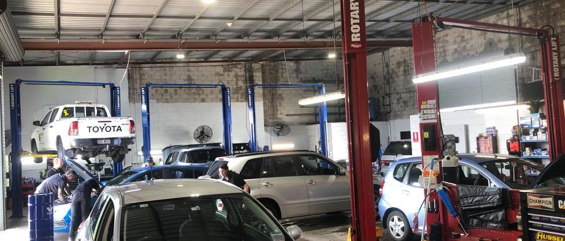Busy day with cars packed in the workshop