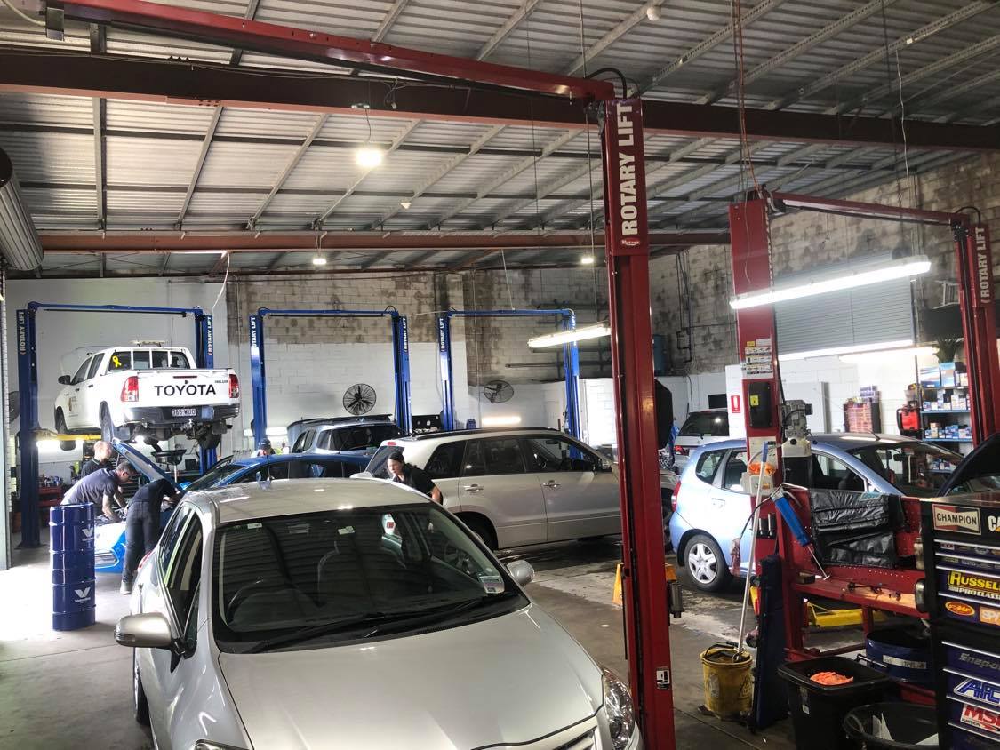 Busy day with cars packed in the workshop