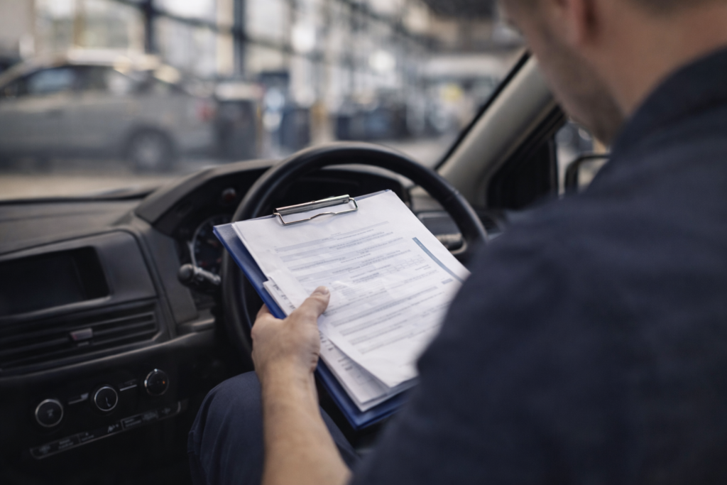 Mechanic reviewing paperwork in workshop