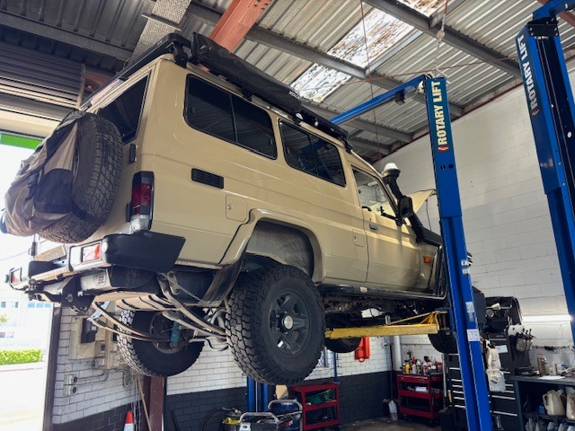 Diesel vehicle on hoist at Revolution Autocare during inspection and repair